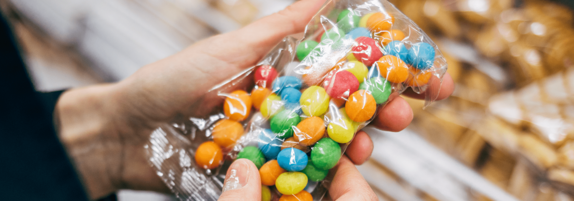 A pair of hands holding a bag of candy