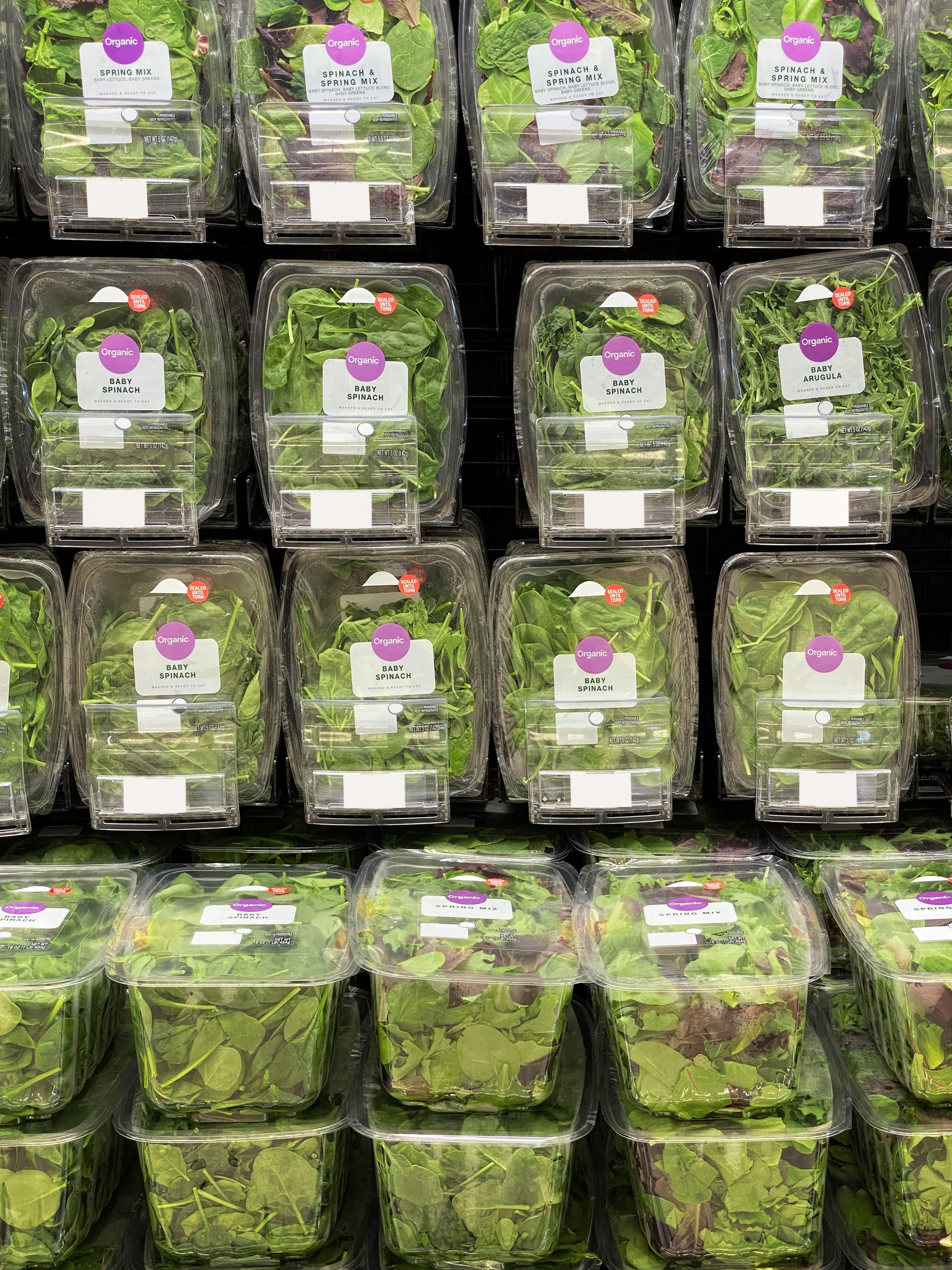 Baby spinach on the grocery store shelves in rigid containers